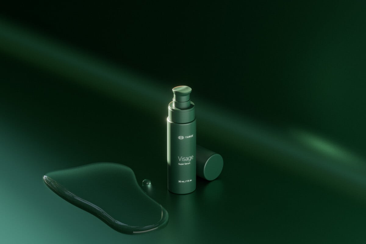 a bottle of visage super serum by three international sitting in a green setting with elegant lighting