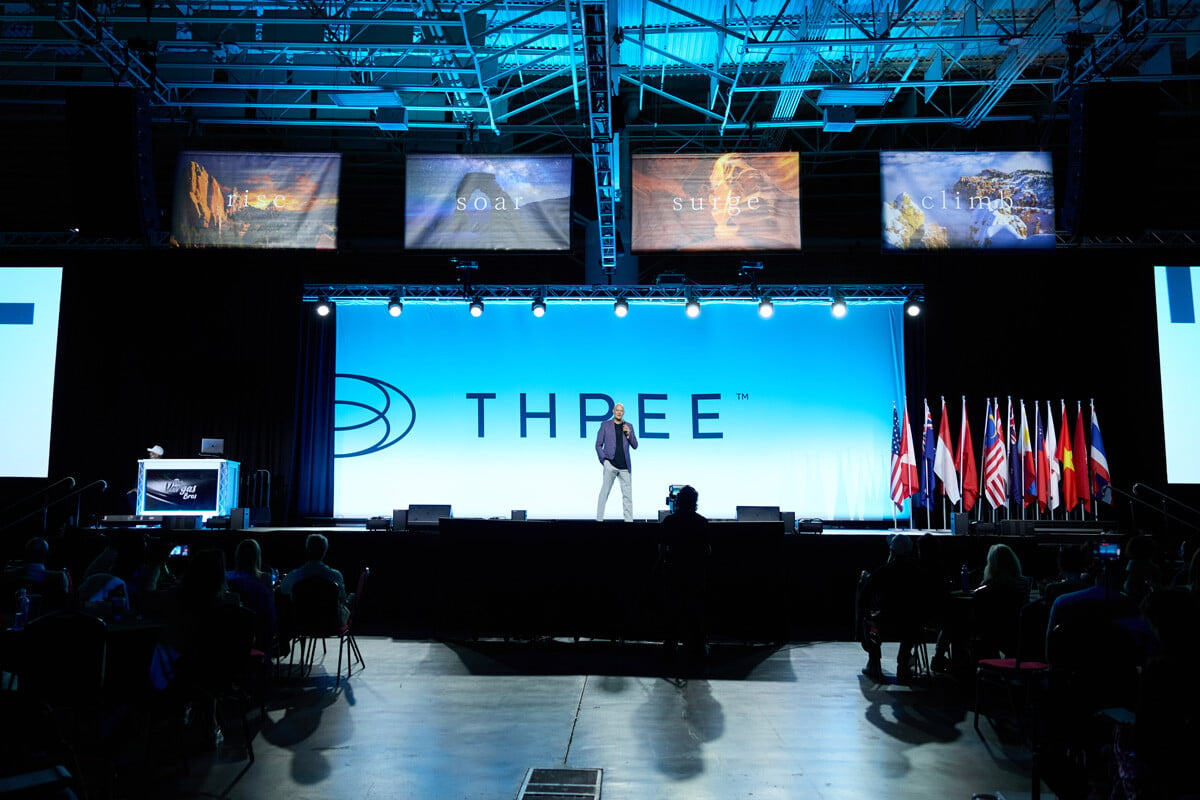 CEO Daniel Picou standing on stage at the 2024 THREE International Salt Lake Convention