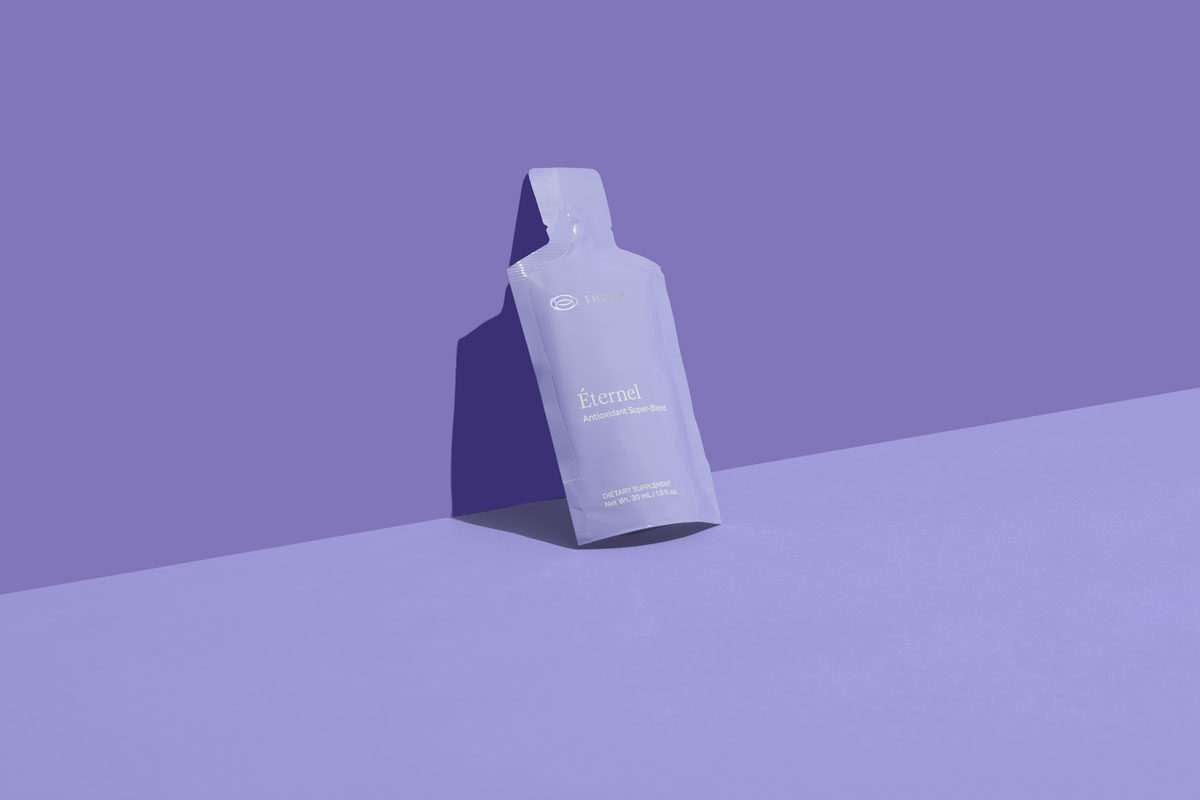 a pouch of Éternel by THREE sitting against a purple wall