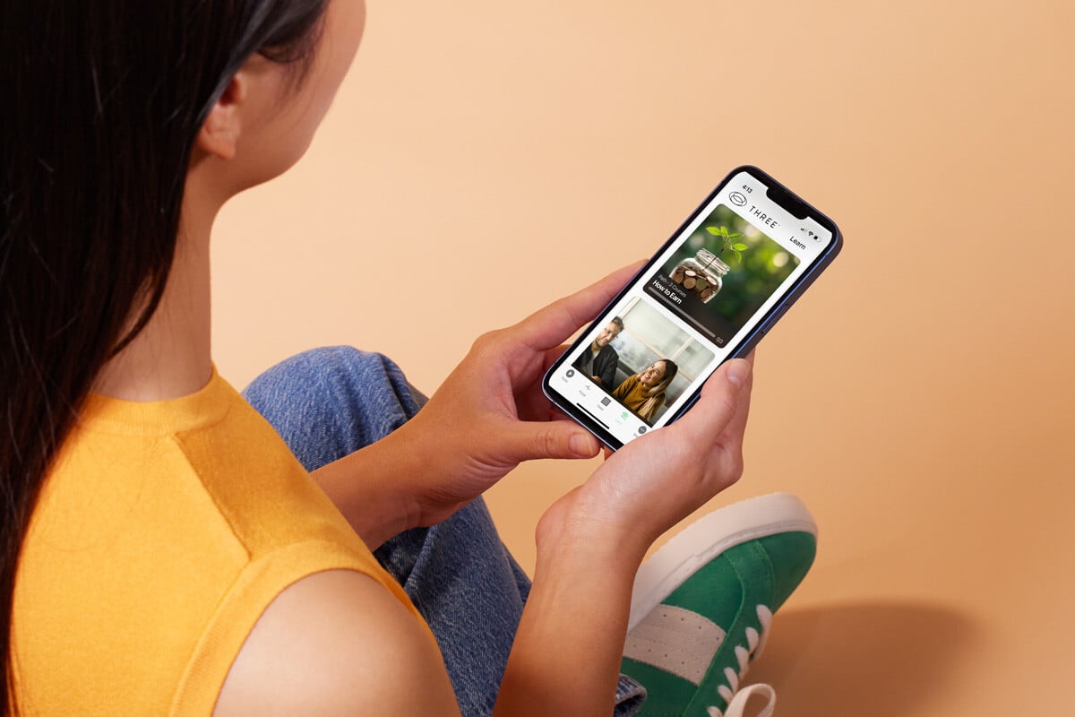 woman using the THREE International app to learn