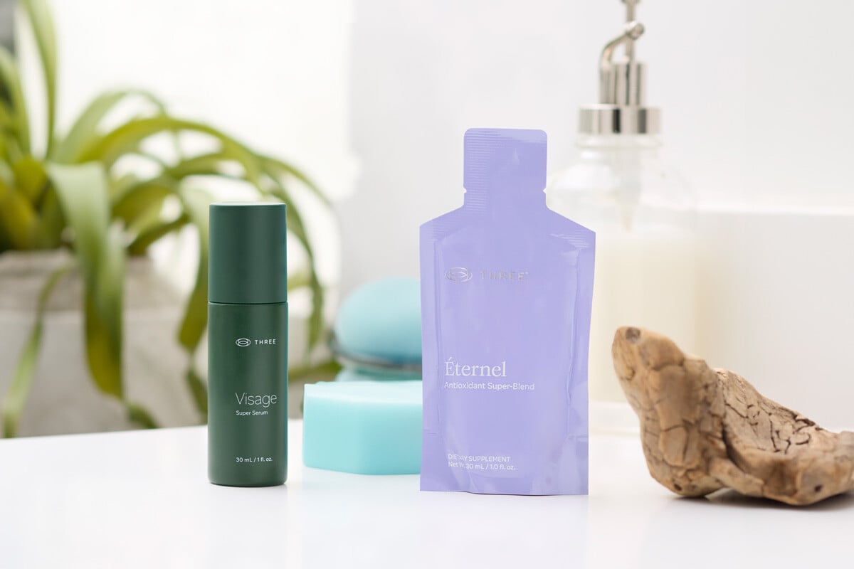 Visage Super Serum and Éternel by THREE together on a bathroom sink
